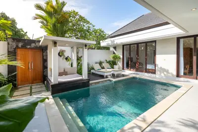 a swimming pool in the backyard of a house at Vansari Serenity Villa in Seminyak