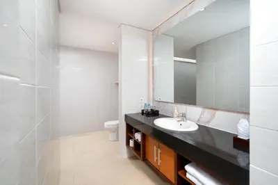 a bathroom with a sink and a mirror at Vansari Serenity Villa in Seminyak