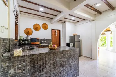 a kitchen with a stone counter top in a room at Bali Dream Villa Legian by iBali Management in Seminyak