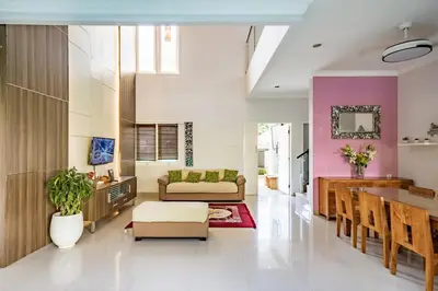 a living room with a couch and a table at Casa Raya 4BR Villa in Kuta in Kuta