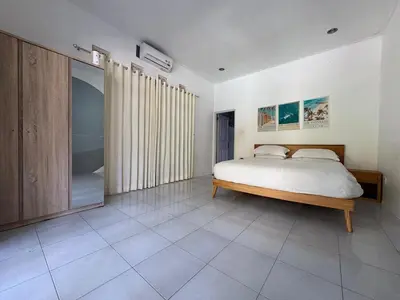 a bedroom with a bed and a large mirror at Villa central seminyak in Seminyak