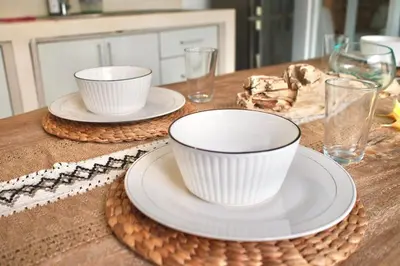 a table with two cups and plates on a table at Villa 2BR Seminyak 8mins Beach in Seminyak