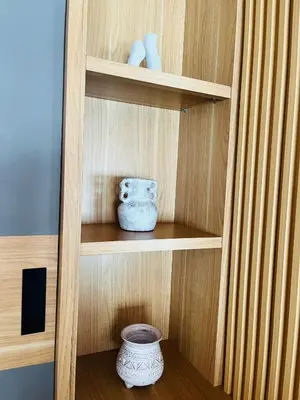 a wooden shelf with two vases on it at Arden Loft in Kerobokan