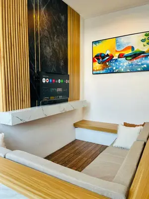 a living room with a couch and a painting at Arden Loft in Kerobokan