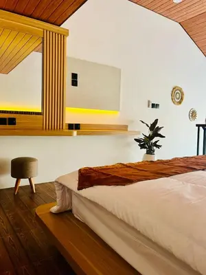 a bedroom with a large bed and a window at Arden Loft in Kerobokan