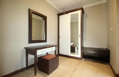 a bathroom with a wooden vanity and a mirror at Djayana Villa Seminyak in Seminyak