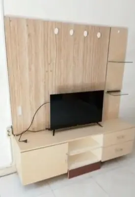 a entertainment center with a television on top of it at Dewata ayu resident in Seminyak