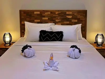 two swans made out of towels sitting on a bed at Villa Sakura Nisa in Seminyak
