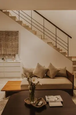 a living room with a bed and a staircase at Villa Casa Rumi in Canggu