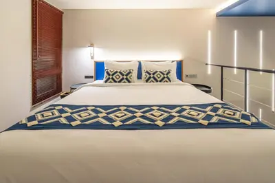 a bedroom with a large white bed with blue accents at First 5 Bedrooms Villa in Seminyak