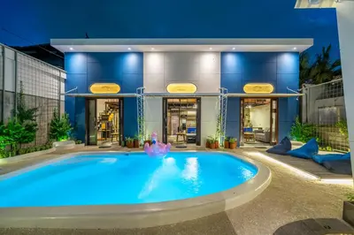a large swimming pool in front of a building at First 5 Bedrooms Villa in Seminyak