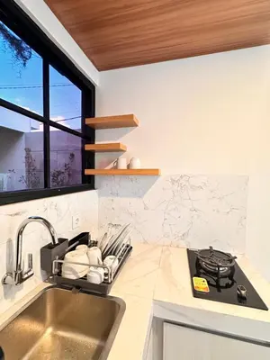 a kitchen with a sink and a window at Kubumanik Loft in Seminyak