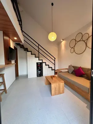 a living room with a couch and a table at Kubumanik Loft in Seminyak