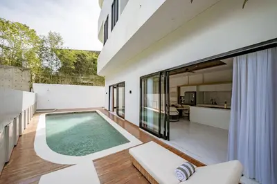 an indoor swimming pool in a house at Aya Townhouses - Prime Location Umalas in Kerobokan