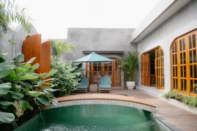 a house with a swimming pool in the yard at Dharman Royal Villas in Kerobokan