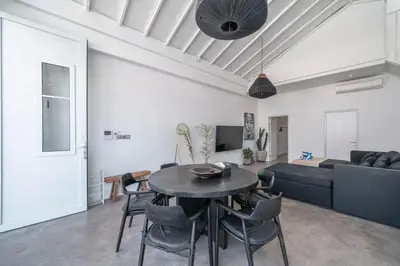 a living room with a table and a couch at Sandy Shores Villa 3 Modern 3BR Villa in Canggu in Canggu