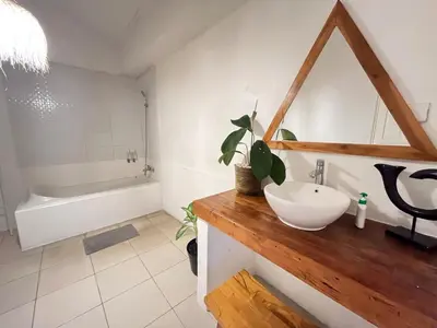 a bathroom with a sink and a bath tub at Kondo Villa 2 BR- Private Pool in Seminyak