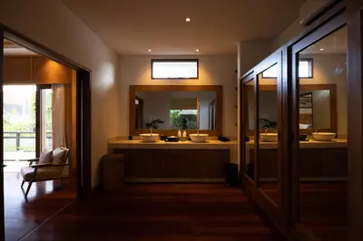 a bathroom with two sinks and a large mirror at Astamaya Signature Villas in Seminyak