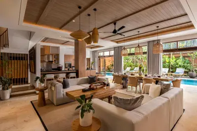 a living room with a couch and a table at Astamaya Signature Villas in Seminyak