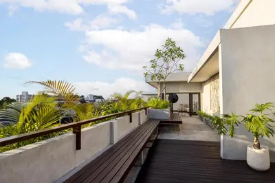a balcony of a house with plants at Astamaya Signature Villas in Seminyak
