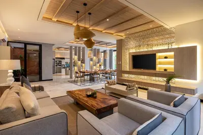 a living room with a couch and a table at Astamaya Signature Villas in Seminyak