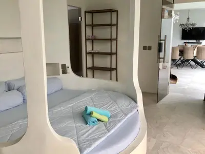 a bed with two towels on it in a room at Villa Denira, Home Gym & Private Pool in Nusa Dua