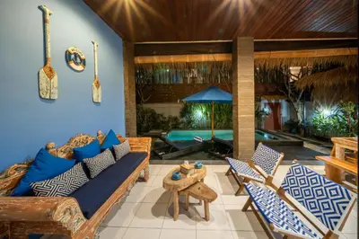 a living room with a couch and chairs at Villa De Ocean in Seminyak