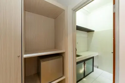 a walk in closet with a glass door at Cove De Pavilla in Sanur
