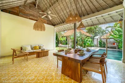 a living room with a table and chairs and a pool at LePalms villa, 2min Beach, 10min Atlas,Finns Club in Canggu