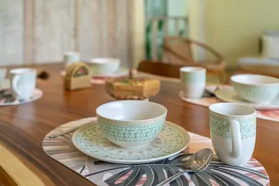 a wooden table with two cups and spoons on it at LePalms villa, 2min Beach, 10min Atlas,Finns Club in Canggu