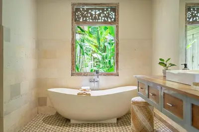 a bath tub in a bathroom with a window at LePalms villa, 2min Beach, 10min Atlas,Finns Club in Canggu
