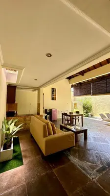 a living room with a couch and a table at Seminyak Classic 1BRoom Private Pool Villa in Seminyak