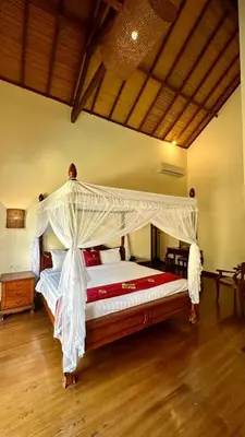 a bedroom with a large bed with a canopy at Seminyak Classic 1BRoom Private Pool Villa in Seminyak
