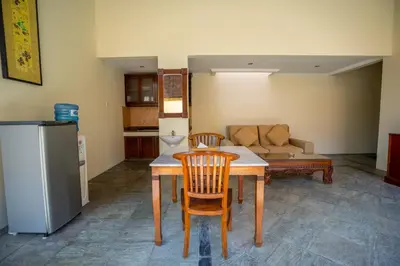 a kitchen with a table and chairs and a couch at Seminyak Classic 1BRoom Private Pool Villa in Seminyak