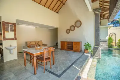 a living room with a table and chairs and a pool at Villa PBC 2 Bed Room Private Pool in Seminyak in Seminyak