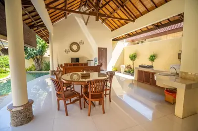 a kitchen and dining room with a table and chairs at Clasic 3BRoom Villa In Seminyak in Seminyak