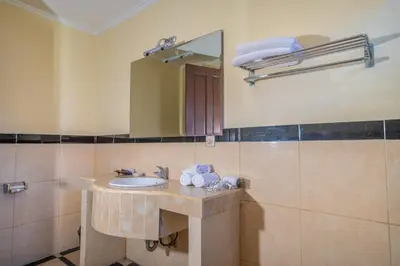 a bathroom with a sink and a mirror at Clasic 3BRoom Villa In Seminyak in Seminyak