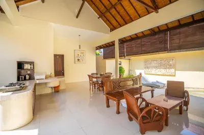 a kitchen and living room with a table and chairs at Clasic 3BRoom Villa In Seminyak in Seminyak