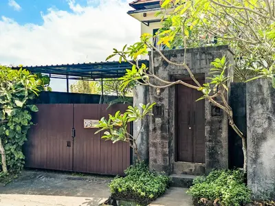 a wooden gate to a house with a fence at The Lavana Villa Singgahan Jimbaran - 3 Bedroom Villa in Nusa Dua