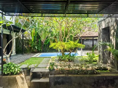 a garden with a pool in a house at The Lavana Villa Singgahan Jimbaran - 3 Bedroom Villa in Nusa Dua