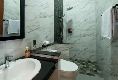 a bathroom with a sink and a toilet at Villa Sakura ll seminyak in Seminyak