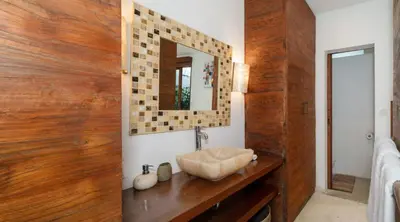 a bathroom with a sink and a mirror at Villa Bidadari With Pool in Seminyak
