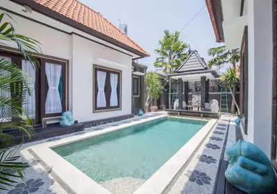 a swimming pool in front of a villa at Villa Marjens 2 Seminyak area Bali in Kerobokan
