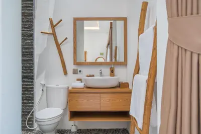 a bathroom with a sink and a toilet at NaraDama Villa Seminyak Bali in Seminyak
