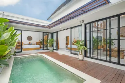 an indoor pool in a villa with a bedroom at NaraDama Villa Seminyak Bali in Seminyak