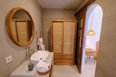 a bathroom with a sink and a mirror at New Vindra I Villa 2BR in the heart of Berawa in Canggu
