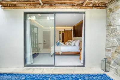 a bedroom with a view of a bed and a pool at Casa De Fiero A4 2BR Villa In Seminyak in Seminyak