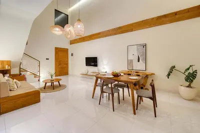 a living room with a table and chairs and a couch at Casa De Fiero A4 2BR Villa In Seminyak in Seminyak