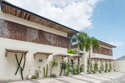 an exterior view of a building with plants at Casa De Fiero A4 2BR Villa In Seminyak in Seminyak