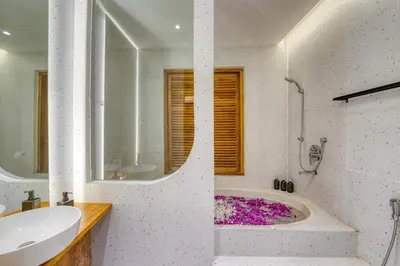 a white bathroom with a tub and a sink at Casa De Fiero A4 2BR Villa In Seminyak in Seminyak